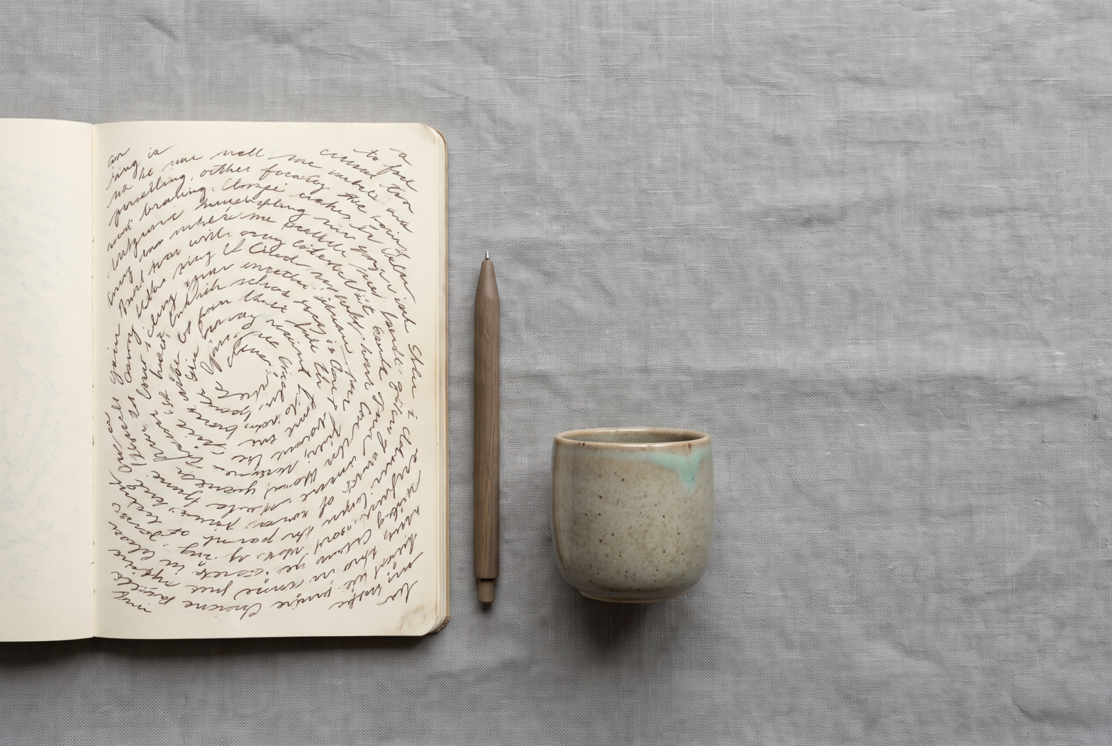 Flat lay of a notebook with the same worried question handwritten and rewritten in small circular loops around the page