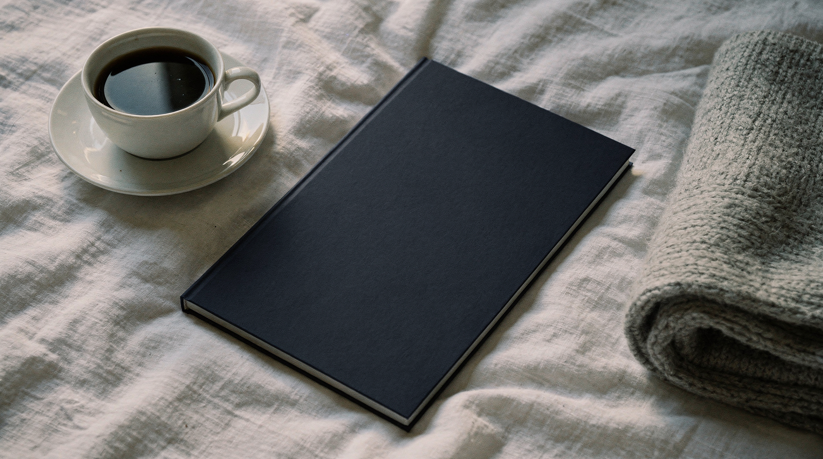 The 3-Minute Pattern Reset Kit booklet on a white linen bed beside a cup of coffee
